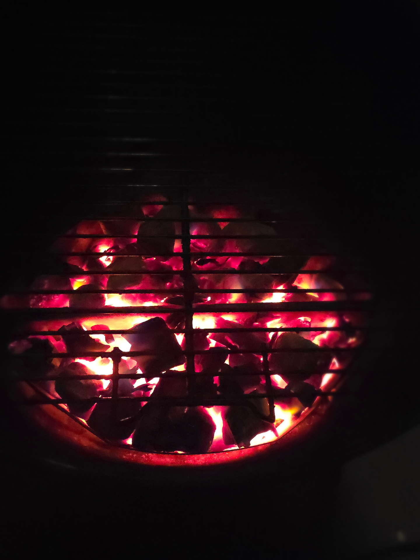 Glowing wood coals at BBQ event